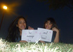 send you 3 photos of me and my twin sister, holding your sign small3