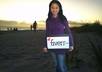 take a photograph holding a sign with your message