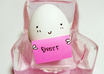 take a picture of a smiling egg sitting in a chair holding a sign advertising your business/saying anything you want